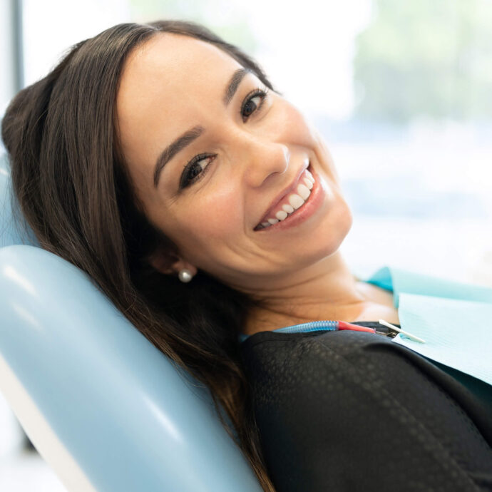 lady reclined in dentist chair smiling at the camera