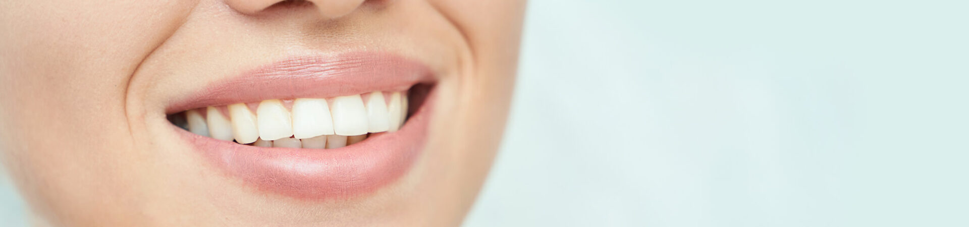 close up of smiling female showing clean white teeth