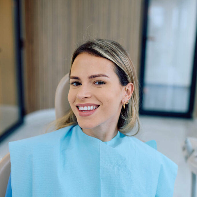 smiling female sitting in dentist chair